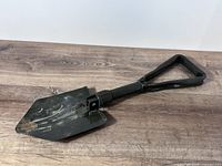 Folding shovel unfolded showing blade and handle