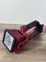 Left-front view of Milwaukee LED search light showing overall condition and design