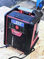 Front view showing display, controls, speaker grille, AC cord