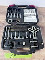 Closed case opened showing full set of bolts, puller yoke, threaded rods and carry case