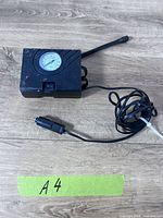 Full view of Slime tire inflator with power cord and hose