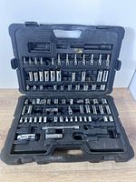 Closed black plastic case opened to show socket rows