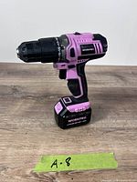 Left profile of pink/black WorkPro cordless drill with battery