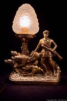 Front view illuminated showing full hunter figure, dogs, crystal shade