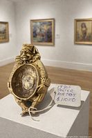 Front view of brass jester ashtray on pedestal