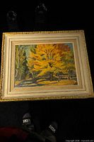Front view of framed autumn landscape painting showing overall artwork and frame