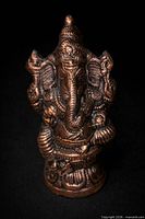 Full front view of bronze-toned Ganesha statue