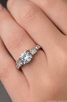 Ring worn on hand showing stone arrangement and band