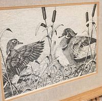 Close view of numbered limited edition duck print in light oak frame