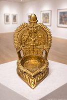 Front view of brass oil lamp on pedestal