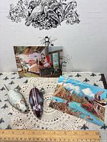 Full lot showing two tin mice, two illustrated postcards on lace mat