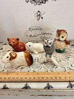 All five Goebel animal figurines with ruler for scale