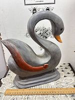 Full left-side view of wood swan on base