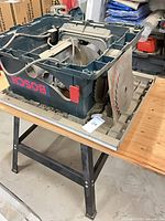 Bosch 4000 table saw body on metal stand, Craftsman blade visible, damaged housing