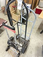 Black and grey upright hand trucks with folding MagnaCart-style cart stacked together