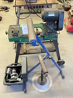 Full view of band saw on stand, roller stand, router case