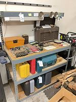 Full view of workbench with shelves, toolboxes and tools