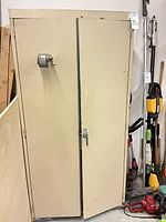 Front view of beige metal cabinet with two doors