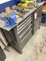 Front view of rolling tool cabinet with drawers and side cabinet, tools on top