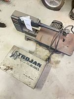 Full view of scroll saw and Trojan Blades box on floor