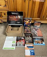 Overview of all DVD sets, opened Insanity packaging, Hip Hop Abs Dance Party sleeve and paper guides