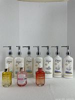 Full lot showing seven Dove pump bottles and three serum dropper bottles