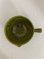 Top view showing floral motif and rim lettering