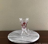 Full view of crystal vase front showing bird motif and cut pattern