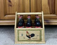 Caddy filled with six Coke bottles, front rooster panel visible