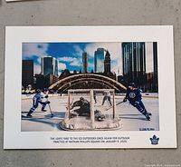 Maple Leafs outdoor practice photo print showing players, net and city backdrop, caption and numbering visible