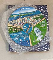 Front of Auckland 3D souvenir plate on box with bubble wrap