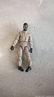 Front view of 2013 GI Joe Beachhead action figure showing full tan uniform and black mask, gloves, boots