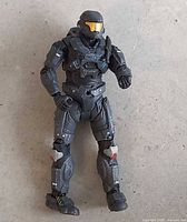 Front view of grey Spartan action figure with gold visor