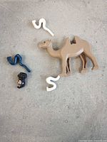 camel, snakes and minifigure head on grey surface