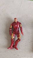 Full view of red and gold Iron Man Mark 3 action figure lying on surface