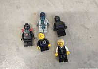 All five LEGO Ninjago minifigures arranged on floor