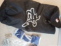 Black small punching bag, partial view of gloves and wraps