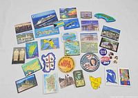 Overview of assorted travel magnets laid out in grid