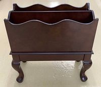 front view of Bombay Company wooden magazine rack on cabriole legs