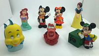 All seven Disney character coin banks arranged in group
