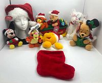 Group shot of all plush items, hat on mannequin, stocking foreground