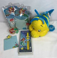 Group view showing all items: plush, watch, stationery, nightlight