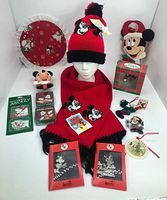 Full lot overview with hat, scarf, boxed items, ornaments, plush, and plate
