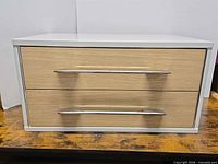 Front view showing two drawers and handles