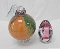 Both paperweights side by side for size and color comparison