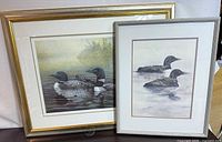 Both framed loon prints side by side, angled view