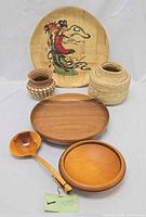 Group shot of all items: ladle, two wooden bowls, bamboo tray, two baskets
