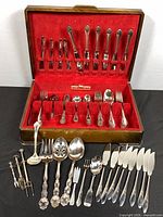 open case showing flatware layout and serving pieces