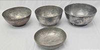 Group shot of four metal bowls showing sizes and designs