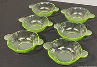 Six green uranium glass bowls front view